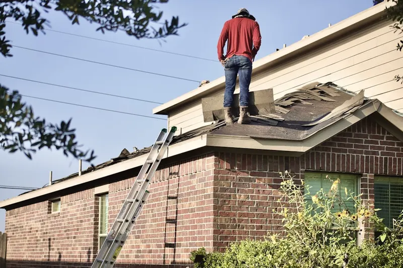 Professional roofer working on a residential roof in Cowell